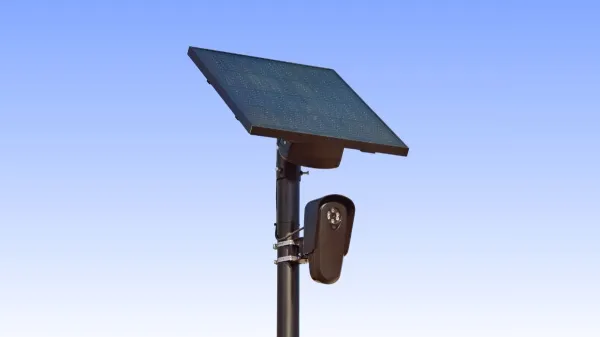 A Flock Safety ALPR camera mounted on a pole beside a public road